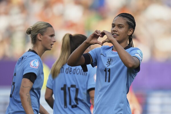 Netherlands' Esmee Brugts, right, celebrates after scoring her side's third goal during the Euro 2025, group D, soccer match between Wales and the Netherlands at Allmend Stadion Luzern in Lucerne, Switzerland, Saturday, July 5, 2025. (AP Photo/Alessandra Tarantino)