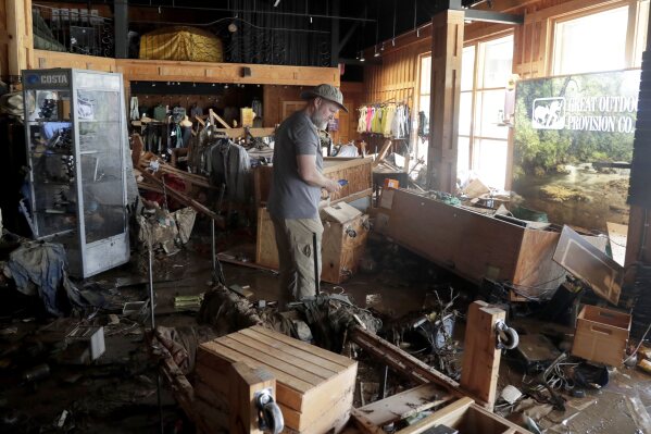 An employee surveys the damage at the Great Outdoor Provision Co. after it was flooded during tropical storm Chantal, Monday, July 7, 2025, in Chapel Hill, N.C. (AP Photo/Chris Seward)