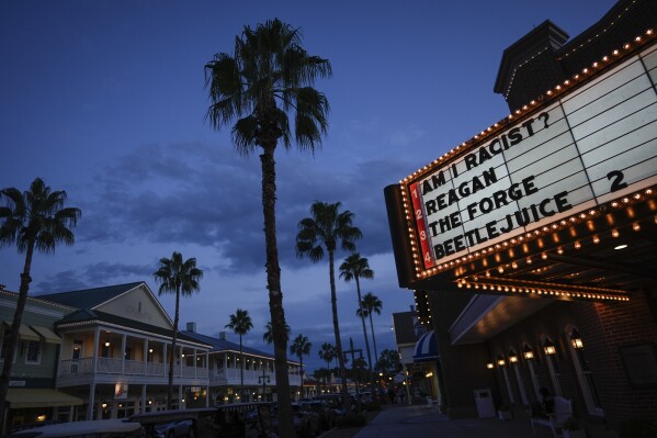 A movie theatre marque shows films currently playing in The Villages, Fla., Sept. 15, 2024.  (AP Photo/Rebecca Blackwell)