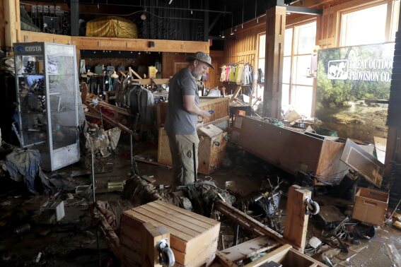 An employee surveys the damage at the Great Outdoor Provision Co. after it was flooded during tropical storm Chantal, Monday, July 7, 2025, in Chapel Hill, N.C. (AP Photo/Chris Seward)