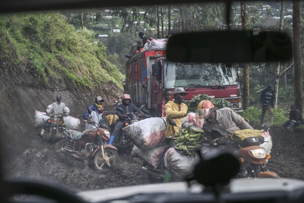 Motorcyclists ride through thick mud on their way to the mining town of Rubaya, Democratic Republic of Congo, on Friday, May 9, 2025. (AP Photo/Moses Sawasawa)