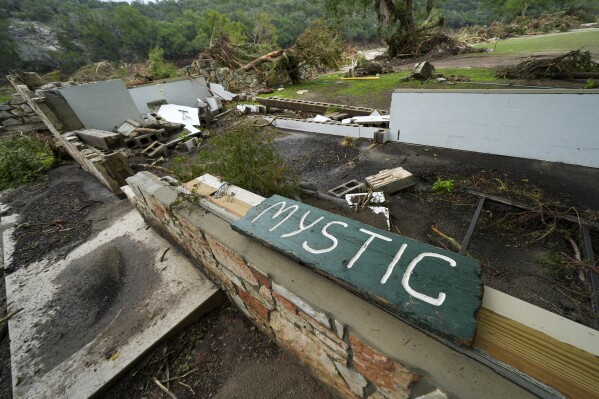 A Camp Mystic sign is seen near the entrance to the establishment along the banks of the Guadalupe River in Hunt, Texas, Saturday, July 5, 2025, after a flash flood swept through the area. (AP Photo/Julio Cortez)