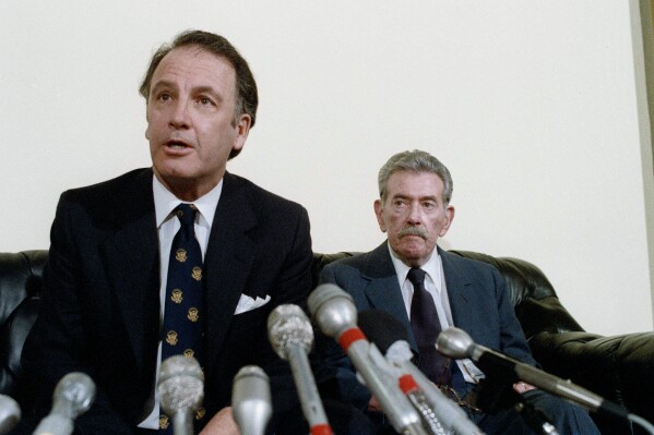 U.S. Rep. Pat Williams, (D-Mont), left, fields questions while seated next to Col. Murray Sanders during a news conference on Japanese World War II germ warfare experiments on American POW's on Capitol Hill in Washington, Dec. 6, 1985. (AP Photo/John Duricka, File)