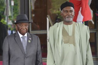 Liberia's President, Joseph Boakai, left, and Nigeria Minister of Foreign Affairs, Yusuf Tuggar, right, pose for a photo, prior to the start of the ECOWAS meeting, in Abuja, Nigeria, July 7, 2024. (AP Photo/Olamikan Gbemiga, File)