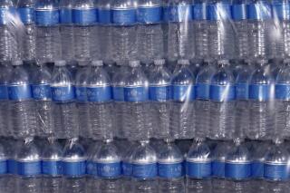 Personalized waters that former President Donald Trump donated sit on a pallet at the East Palestine Fire Department as he visits the area following the Norfolk Southern train derailment Feb. 3 in East Palestine, Ohio, Wednesday, Feb. 22, 2023. On Friday, Feb. 24, 2023, The Associated Press reported on false online claims that the water he donated was discolored. (AP Photo/Matt Freed)