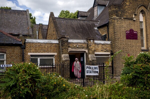 A woman exits a polling station set up at St. Anne's Church, Bermondsey, in London, on July 4, 2024. (AP Photo/Vadim Ghirda, File)