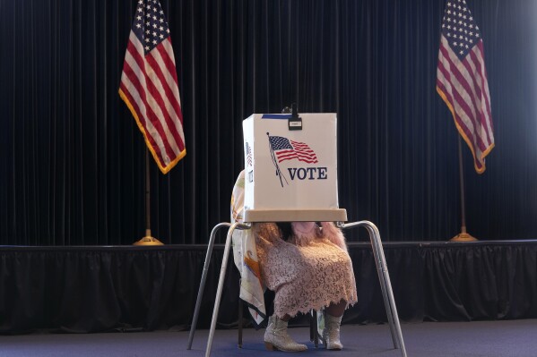 A voter works on her ballot at a polling place at the Ronald Reagan Presidential Library on Election Day, Tuesday, Nov. 5, 2024, in Simi Valley, Calif. (AP Photo/Chris Pizzello)