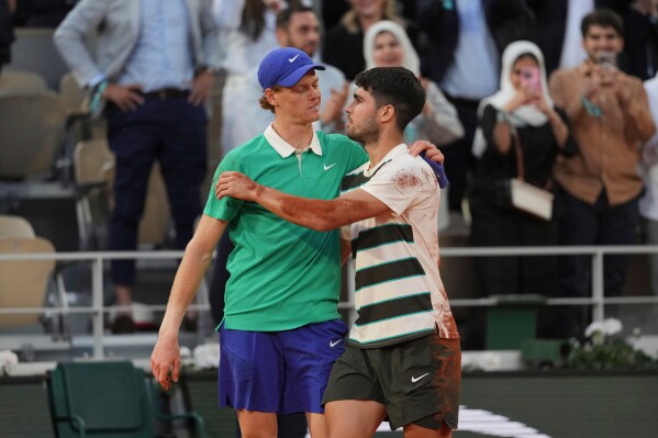 Winner Spain's Carlos Alcaraz, right, and Italy's Jannik Sinner hug after the final match of the French Open tennis tournament at the Roland-Garros stadium in Paris, June 8, 2025. (AP Photo/Thibault Camus, File)