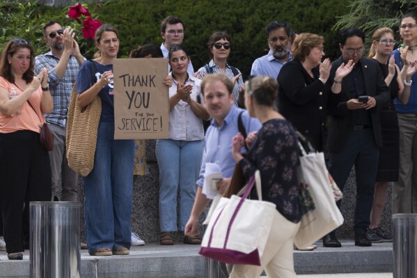 State Department employees applaud as their colleagues walk outside of the State Department headquarters in the Harry S Truman Building, Friday, July 11, 2025, in Washington. (AP Photo/Manuel Balce Ceneta)