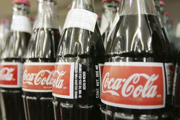 Bottles of Mexican Coca-Cola fill a prominent spot on the shelves of the Tarascas Latino Supermarket in Lawrenceville, Ga., Nov. 3, 2004. (AP Photo/RicFeld, File)