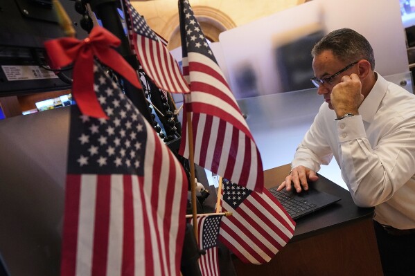 Trader Jason Hardzewicz works on the floor of the New York Stock Exchange, Tuesday, July 1, 2025. (AP Photo/Richard Drew)