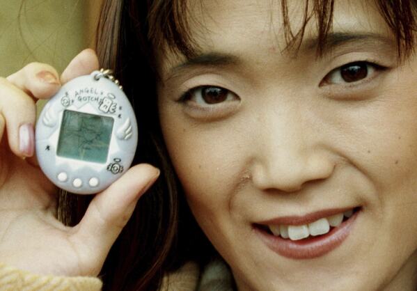 Aki Maita, Japanese developer of the Tamagotchi digital pet, shows on Monday, December 15, 1997 the new product AngelGotchi after a press conference in Hamburg, Germany. (AP Photo/Oliver Fantitsch, file)