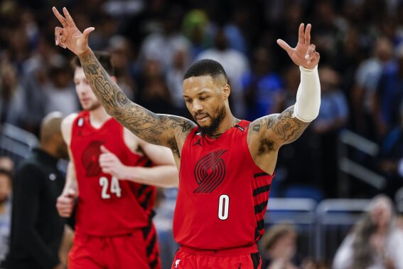 Portland Trail Blazers guard Damian Lillard (0) celebrates after a shot against the Orlando Magic during the second half of an NBA basketball game, March 5, 2023, in Orlando, Fla. (AP Photo/Kevin Kolczynski, File)