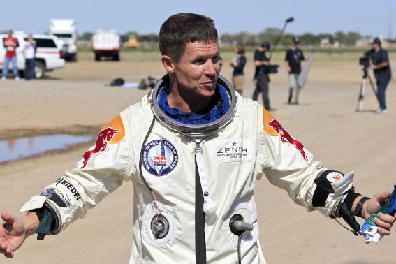 Felix Baumgartner of Austria gestures prior to speaking with the media after successfully jumping from a space capsule lifted by a helium balloon in Roswell, N.M., Oct. 14, 2012. (AP Photo/Ross D. Franklin, File)