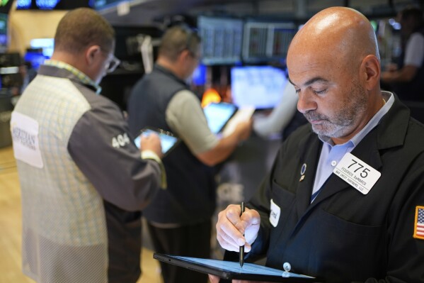 Fredrico DeMarco works on the floor at the New York Stock Exchange in New York, Monday, July 14, 2025. (AP Photo/Seth Wenig)