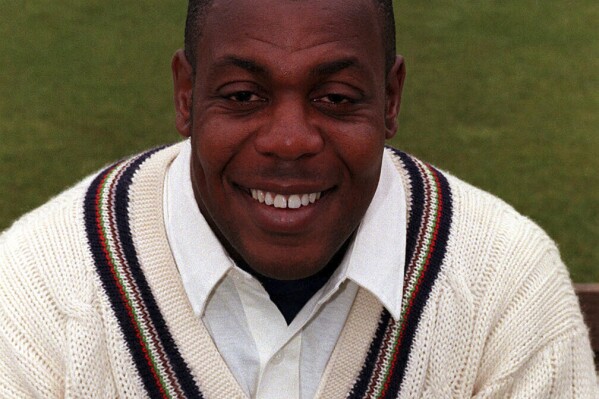 PA FILE - David 'Syd' Lawrence of Gloucestershire County Cricket Team, the first British-born black cricketer to play for England, smiles on June 2, 1998, Lawrence has died at the age of 61. (PA via AP)