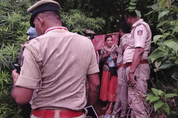 Indian policemen rescue Nina Kutina, 40, a Russian woman, from a cave in forest area of Ramtirtha hills in southern Indian state of Karnataka, Wednesday, July 9, 2025. (Uttara Kannada District Police via AP)