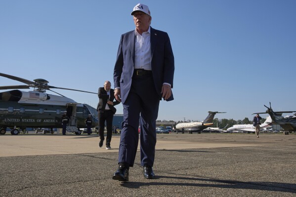 President Donald Trump walks toward the media to speak with them before boarding Air Force One, at Morristown Municipal Airport in Morristown, N.J., Sunday, July 6, 2025, en route to Washington after a weekend in New Jersey. (AP Photo/Jacquelyn Martin)
