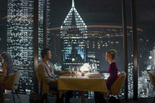 This image released by Universal Pictures shows Brandon Sklenar, left, and Meghann Fahy in a scene from "Drop." (Universal Pictures via AP)