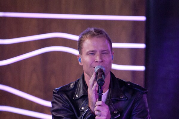 Brian Littrell, of the Backstreet Boys, attends a meeting with fans for the presentation of the album 'In A World Like This' at 40 Cafe in Madrid, Spain, Nov. 12, 2013. (AP Photo/Abraham Caro Marin, file)