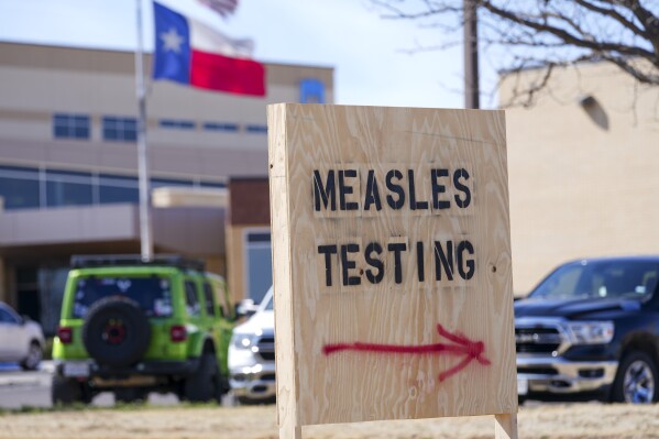 A sign is displayed outside the Seminole Hospital District offering measles testing, Feb. 21, 2025, in Seminole, Texas. (AP Photo/Julio Cortez, File)
