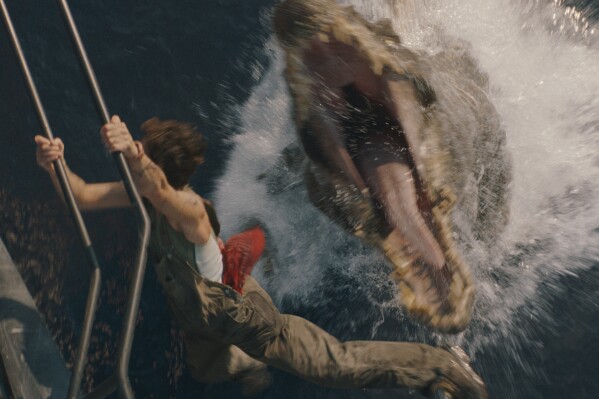 This image released by Universal Pictures and Amblin Entertainment shows Philippine Velge in a scene from " Jurassic World: Rebirth." (Jasin Boland/Universal Pictures and Amblin Entertainment via AP)