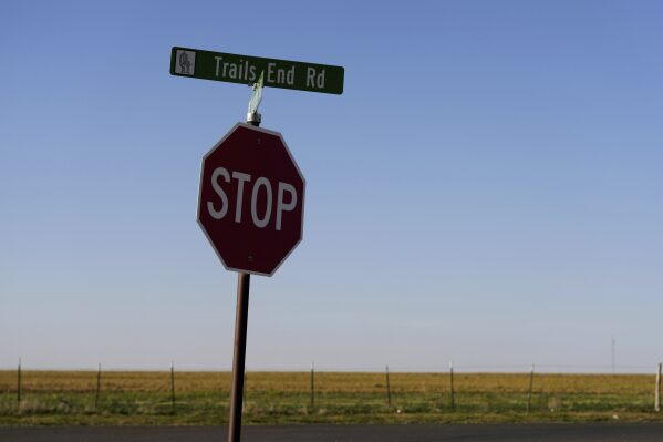 A sign for Trails End Road, home to the JBS meat processing plant, rests on a stop sign, Tuesday, April 15, 2025, in Dumas, Texas. (AP Photo/Eric Gay)