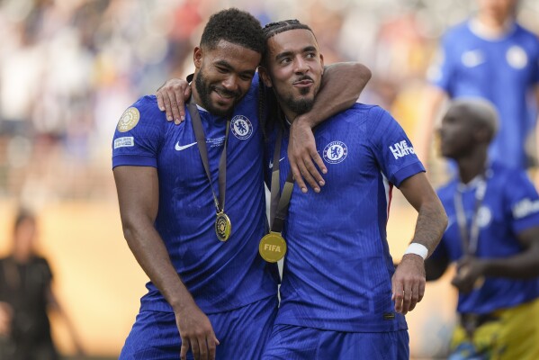 Chelsea's Reece James, left, and Malo Gusto celebrate after defeating Paris Saint-Germain in the Club World Cup final soccer match in East Rutherford, N.J., Sunday, July 13, 2025. (AP Photo/Frank Franklin II)