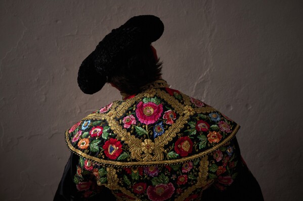 Peruvian bullfighter Andres Roca Rey pauses before entering the bullring during a bullfight at the San Fermin Festival in Pamplona, northern Spain, Friday, July 11, 2025. (AP Photo/Miguel Oses)