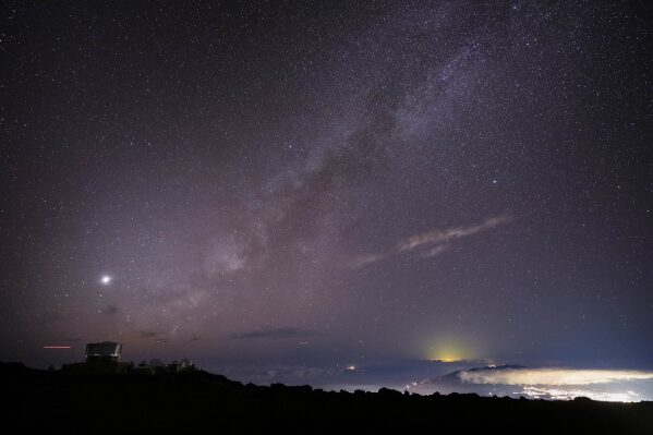 The Milky Way is seen over the Haleakala Observatory and the lights of Kahului, at right, Saturday, Nov. 23, 2024 at the summit of Haleakala National Park near Kula, Hawaii. (AP Photo/Lindsey Wasson, File)
