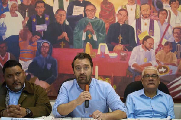 Noah Bullock, director of the human rights organization Cristosal, center, gives a press conference in Guatemala City, Thursday, July 17, 2025, to announce that Cristosal is suspending their activities in El Salvador. (AP Photo/Moises Castillo)