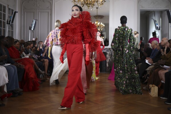 A model wears a creation as part of the Imane Ayissi Fall-Winter 2025/26 Haute Couture collection presented Monday, July 7, 2025, in Paris. (AP Photo/Tom Nicholson)