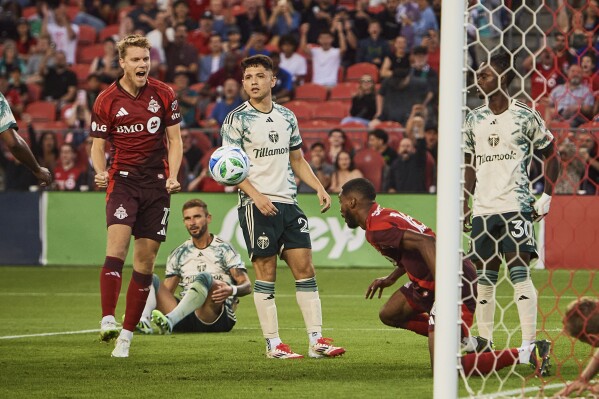 Toronto FC defender Sigurd Rosted (17) and Toronto FC forward Tyrese Spicer (16) celebrate after Spicer scored against the Portland Timbers during second half MLS action in Toronto, Saturday, June 28, 2025. (Sammy Kogan/The Canadian Press via AP)