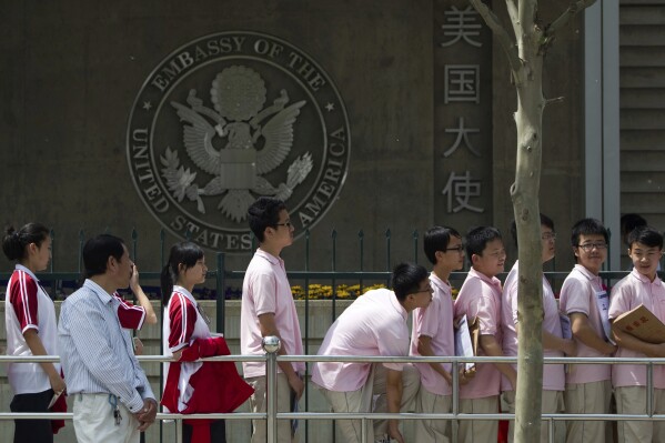 Chinese students wait outside the U.S. Embassy for their visa application interviews, in Beijing on May 2, 2012. (AP Photo/Alexander F. Yuan, File)