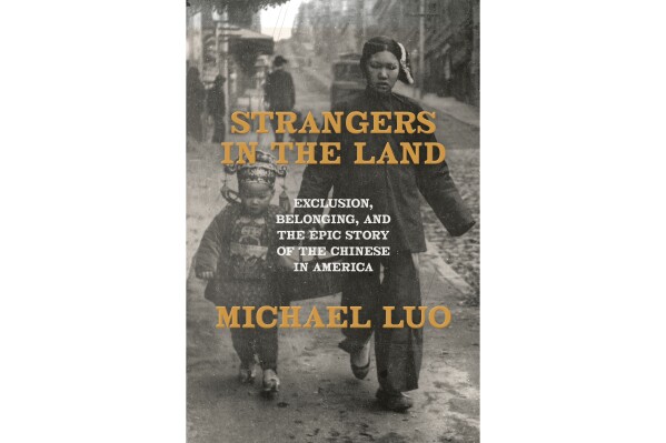 This cover image released by Doubleday shows "Strangers in the Land: Exclusion, Belonging, and the Epic Story of the Chinese in America” by Michael Luo. (Doubleday via AP)