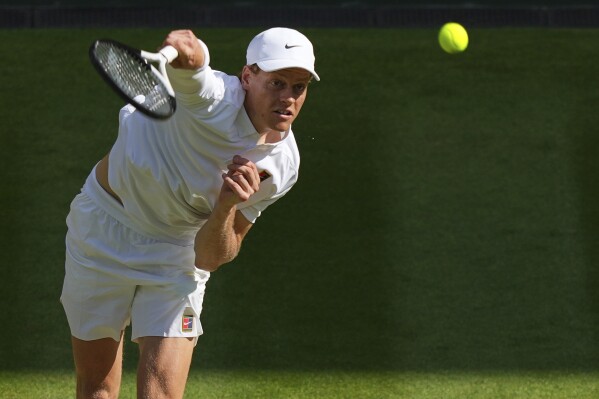 Italy's Jannik Sinner serves to Carlos Alcaraz of Spain in the men's singles final at the Wimbledon Tennis Championships in London, Sunday, July 13, 2025. (AP Photo/Joanna Chan)