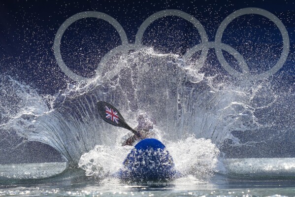 Kimberley Woods of Britain competes in the women's kayak cross time trial at the 2024 Summer Olympics, Friday, Aug. 2, 2024, in Vaires-sur-Marne, France. (AP Photo/Kirsty Wigglesworth)