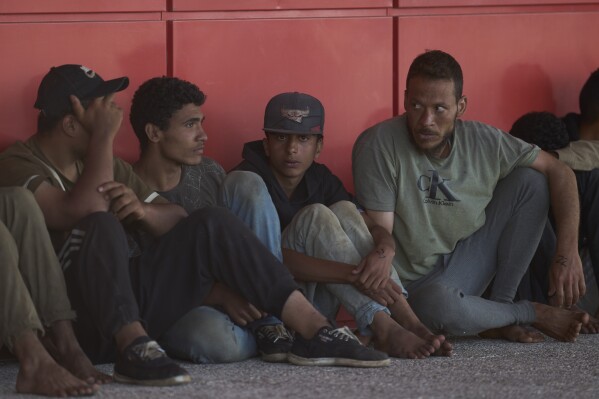 Migrants rescued south of Crete wait to be registered on their arrival at the the port of Lavrio, Greece, on Thursday, July 10, 2025. (AP Photo/Petros Giannakouris)