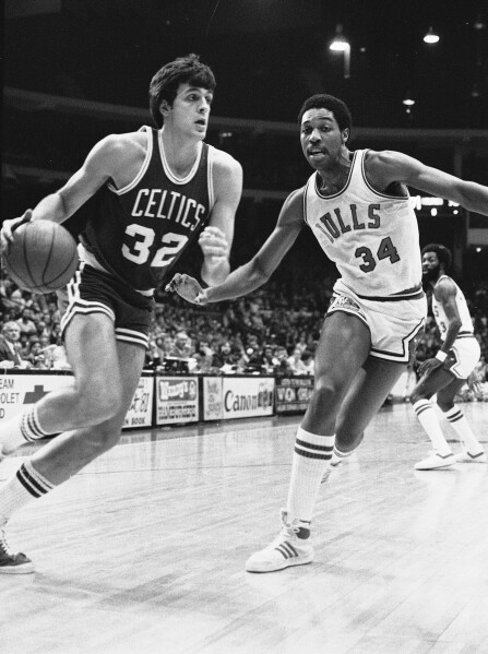 Boston Celtics' Kevin McHale (32) drives as David Greenwood (34) of the Chicago Bulls attempts to catch up during NBA action in Chicago, Nov. 18, 1980. (AP Photo/Fred Jewell, File)