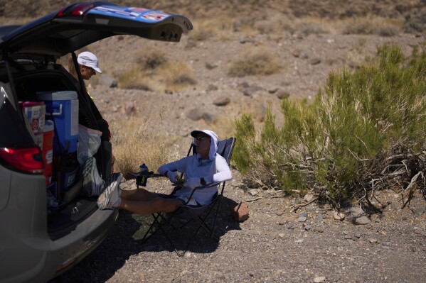 Danny Westergaard takes a break while competing in the Badwater 135 Ultramarathon, Tuesday, July 8, 2025, in Death Valley National Park, Calif. (AP Photo/John Locher)