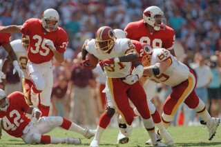 An unidentified Phoenix Cardinals defender tries to stop Washington Redskins wide receiver Art Monk during their game, Sept. 12, 1993 at RFK Stadium in Washington. (AP Photo/Mark Wilson, file)