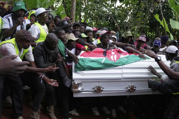 Boniface Kariuki, a vendor who was shot at close range by a police officer during last month's protests, is laid to rest at his parents' farm in Kangema, Muranga County, Kenya, Friday, July 11, 2025. (AP Photo/Brian Inganga)