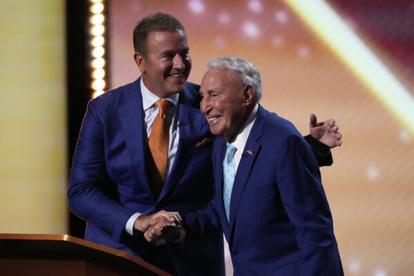 Kirk Herbstreit, left, greets Lee Corso on stage at the ESPY Awards at the Dolby Theatre in Los Angeles, Wednesday, July 16, 2025. (AP Photo/Mark J. Terrill)