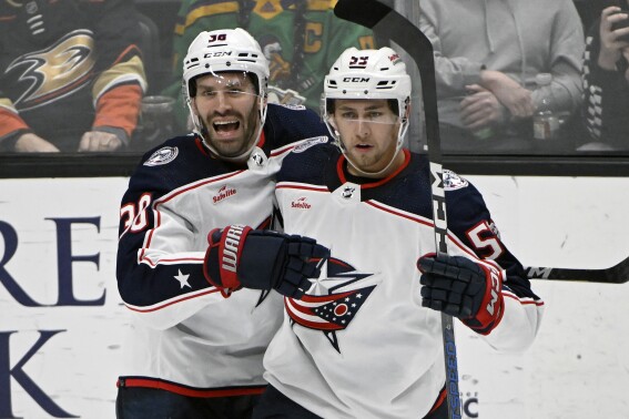 Columbus Blue Jackets center Boone Jenner (38) celebrates a goal by right wing Yegor Chinakhov, right, against the Anaheim Ducks during the third period of an NHL hockey game in Anaheim, Calif., Feb. 21, 2024. (AP Photo/Alex Gallardo, File)