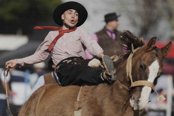 Sebastian Campos rides a horse at a rodeo celebrating Independence Day in San Isidro, Argentina, Wednesday, July 9, 2025. (AP Photo/Natacha Pisarenko)