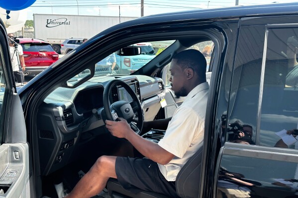 Richard Pryor sits behind the wheel of a new 2025 Ford F-150 pickup at a Ford dealership Thursday, July 10, 2025, in Wayne, Mich. (AP Photo/Corey Williams)