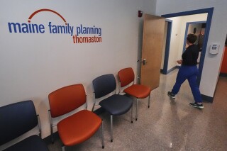 Vanessa Shields-Haas, a nurse practitioner, walks from the lobby toward the examination rooms at the Maine Family Planning healthcare facility, July 15, 2025, in Thomaston, Maine. (AP Photo/Charles Krupa)