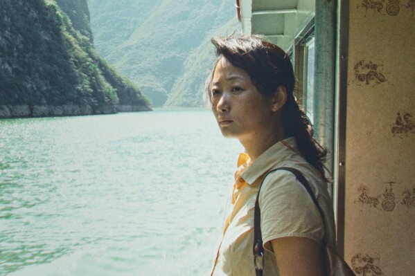 This image released by Sideshow and Janus Films shows Tao Zhao in a scene from "Caught By the Tides." (Sideshow and Janus Films via AP)