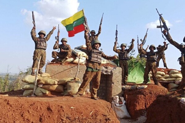 In this image released on July 16, 2025, by The Myanmar Military True News Information Team, soldiers are seen celebrating a victory at one of the captured outposts in Nawnghkio, a township that the Ta'ang National Liberation Army controlled for over a year, in northern part of Shan state, Myanmar. (The Myanmar Military True News Information Team via AP)