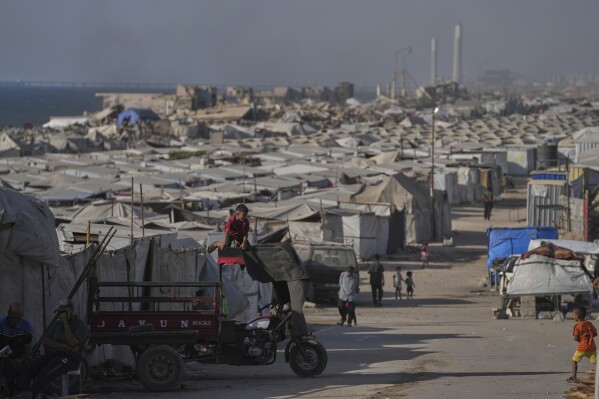 A camp of tents housing displaced Palestinians extends across Gaza City, Thursday, July 17, 2025. (AP Photo/Jehad Alshrafi)